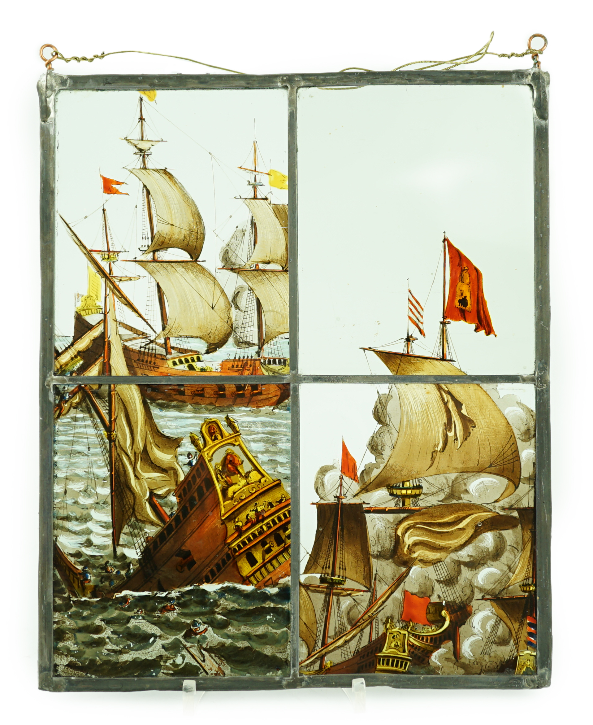 A 18th century Dutch stained glass panel made from four sections depicting a shipwreck and the sails of a fighting galleon, overall 28 x 23cm